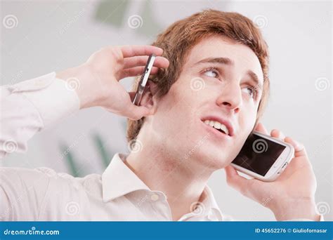 Man In White With Two Mobile Phones Stock Photo Image Of Overwhelmed