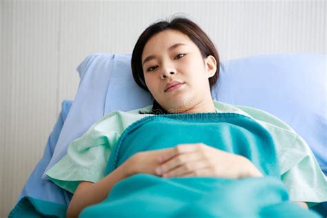 Asian Young Sick Ill Female Patient Wears Green Hospital Uniform Lay