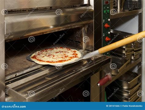 Putting Pizza In Oven Royalty Free Stock Image - Image: 30141666