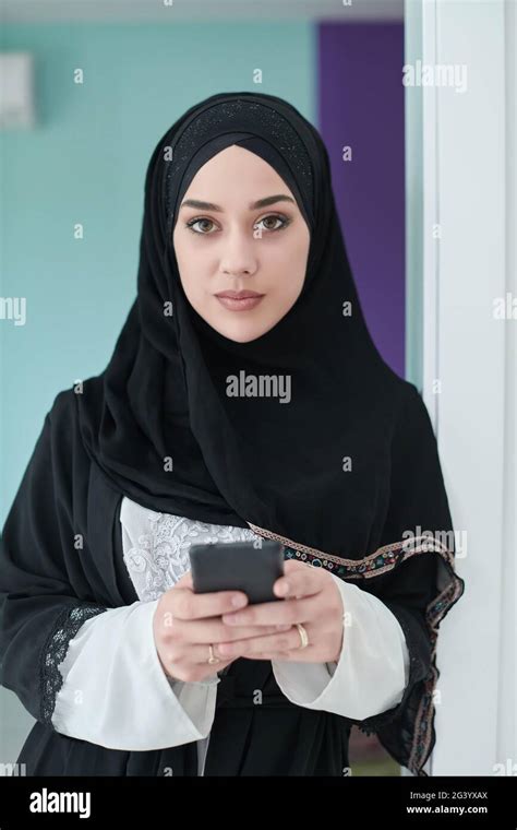 Portrait Of Arab Woman In Traditional Clothes Using Mobile Phone Stock