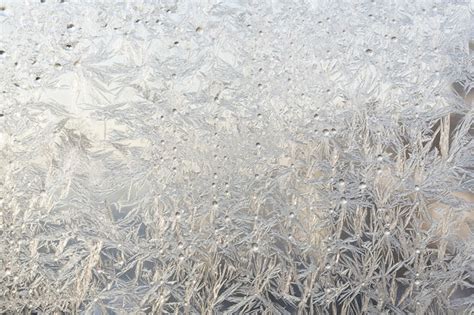 Premium Photo Frost Patterns At Window Glass Closeup