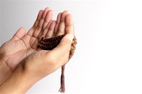 Premium Photo Close Up Of Cropped Hands Holding Prayer Beads Against