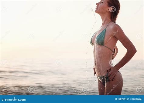 Happy Woman Wearing Bikini Is Playing And Splashing In The Sea Stock