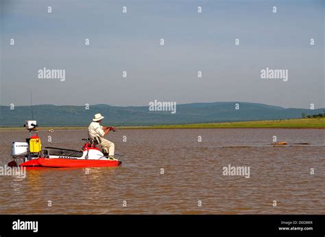 An Angler On An Aquaquad Boat Casts For Tiger Fish In Pretty Lake