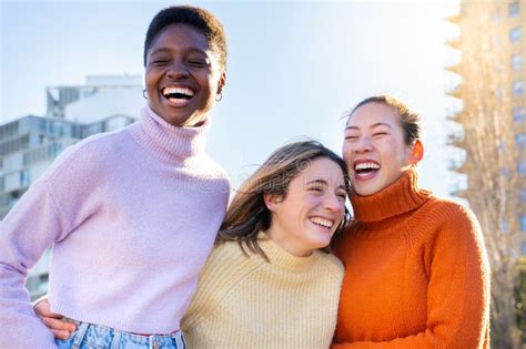 Cheerful Multiracial Group Of Young Women Friends Enjoy Laugh Hug And Have Fun Together