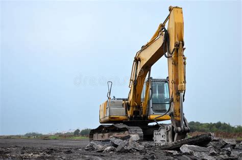 Large Tracked Excavator With Hydraulic Hammer Breaks Asphalt At A