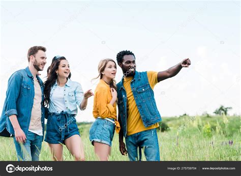 Happy African American Man Pointing Finger While Standing Friends Stock