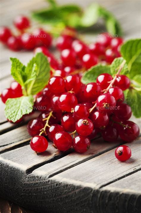 Red currant and mint on the wooden table