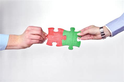 Group Of Business People Assembling Jigsaw Puzzle Stock Photo