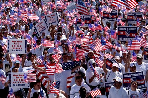 [large Crowd Of Immigration Protesters Holding Signs And Waving