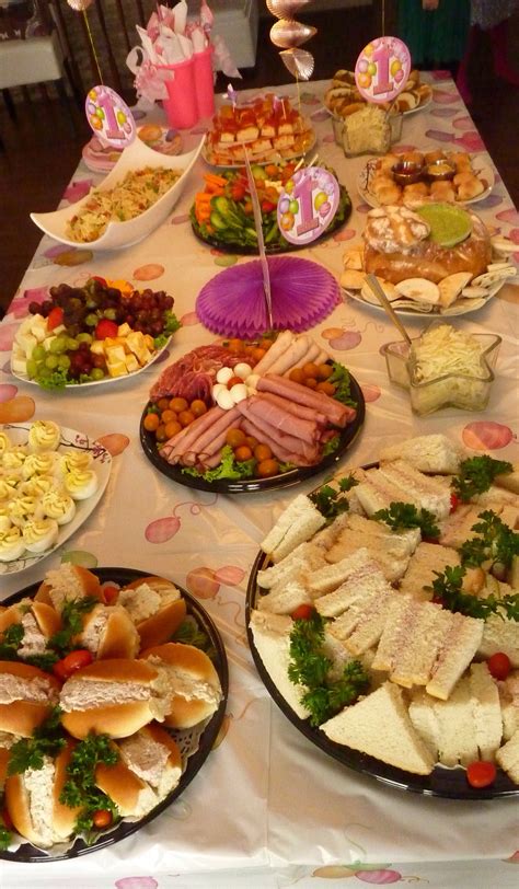 A Table Topped With Lots Of Plates Filled With Sandwiches And Salads