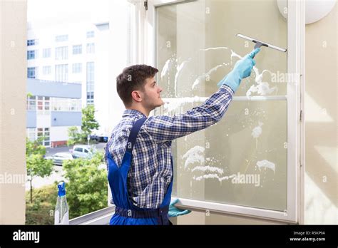 Housekeeper Cleaning Window Stock Photo Alamy