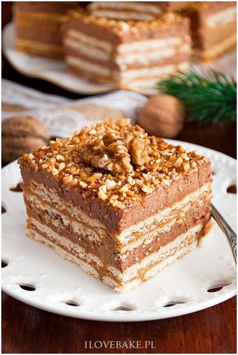 A Piece Of Layered Cake On A Plate With A Fork In Front Of The Rest