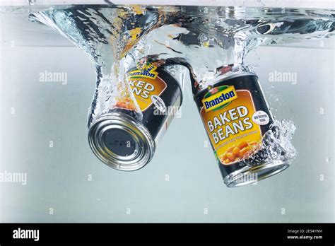 Hi Speed Shot Of Two Tins Of Baked Beans Dropping Into Water Ultra Hi