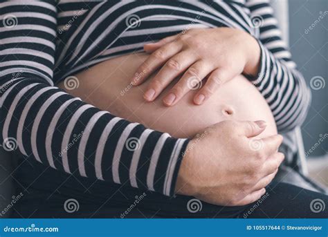 Gentle Loving Pregnant Female With Hands On Her Belly Stock Photo