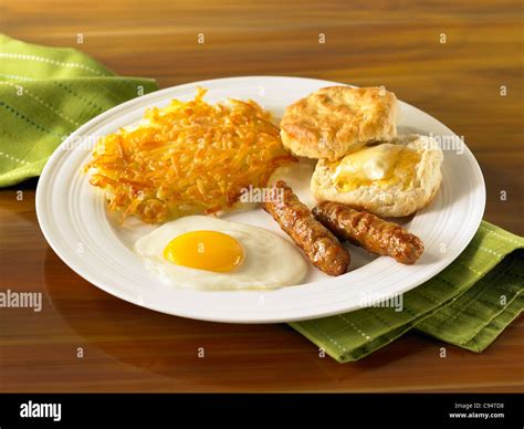 Egg Breakfast With Hash Browns Sausage And Biscuits With Butter Stock