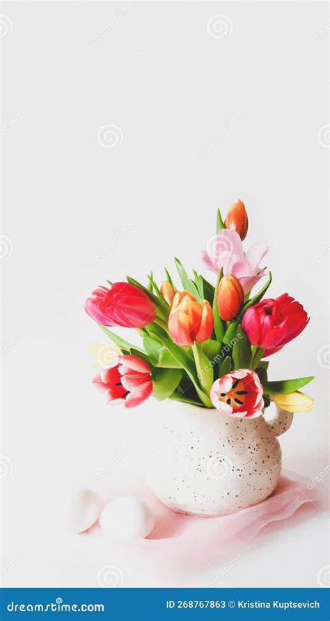 Easter Still Life With Multicolored Tulips In A Jug And White Eggs