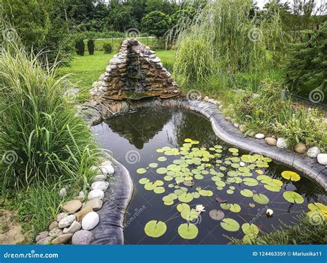 Artificial Fish Pond with Small Waterfall Stock Image - Image of plants ...