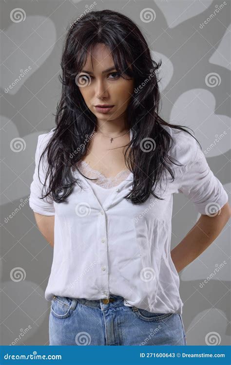 A Beautiful Brunette Woman In A Casual Outfit In The Studio Stock Image