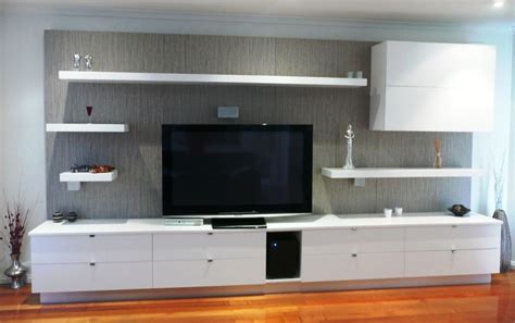 White Tv Media Wall Unit With Led Lighting Under The Shelves And A