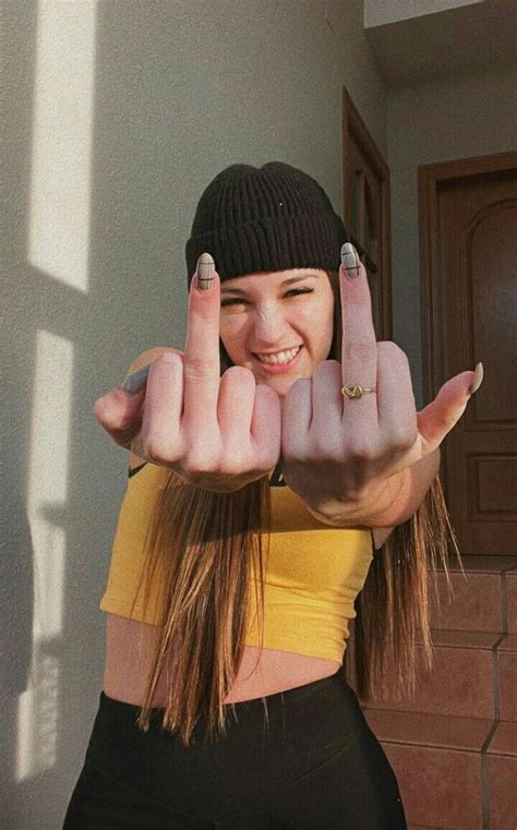 A Woman Making The Vulcan Sign With Her Hands In Front Of Her Face And