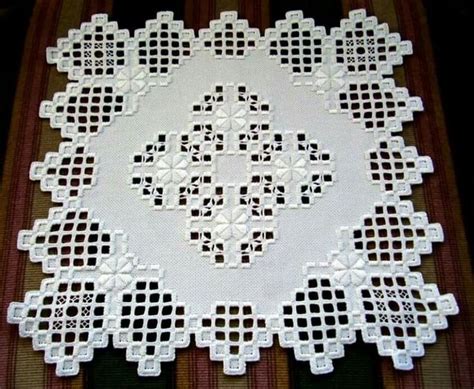 A White Doily With Black Dots On It