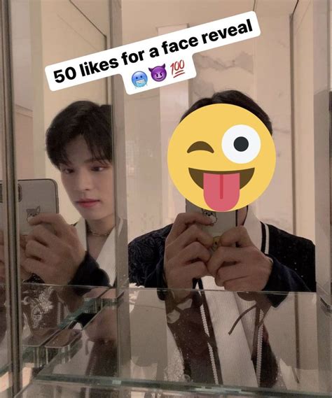 A Man Taking A Selfie In Front Of A Mirror With An Emoticive Sticker On