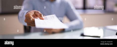 African Business Man Giving Paycheck Stock Photo Alamy