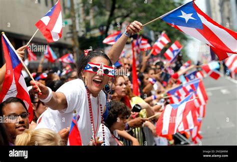 Puerto Rican flags wave as spectators line Fifth Avenue during the ...