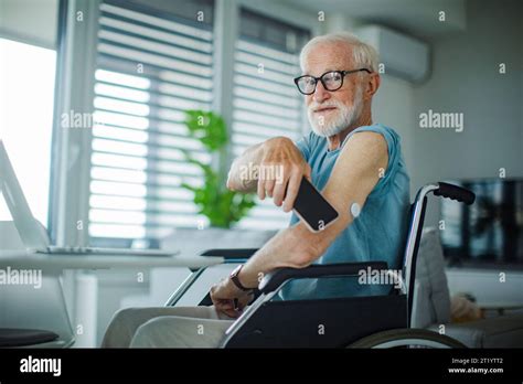 Diabetic Senior Man Checking Blood Glucose Level Using Continuous