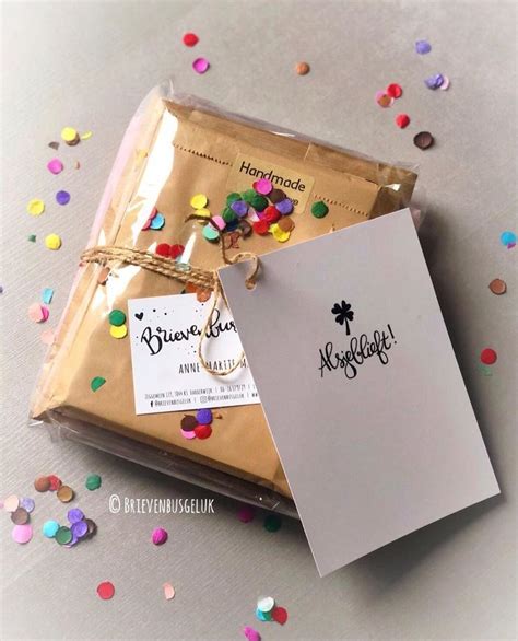 Two Bags Of Confetti And A Card On A Table