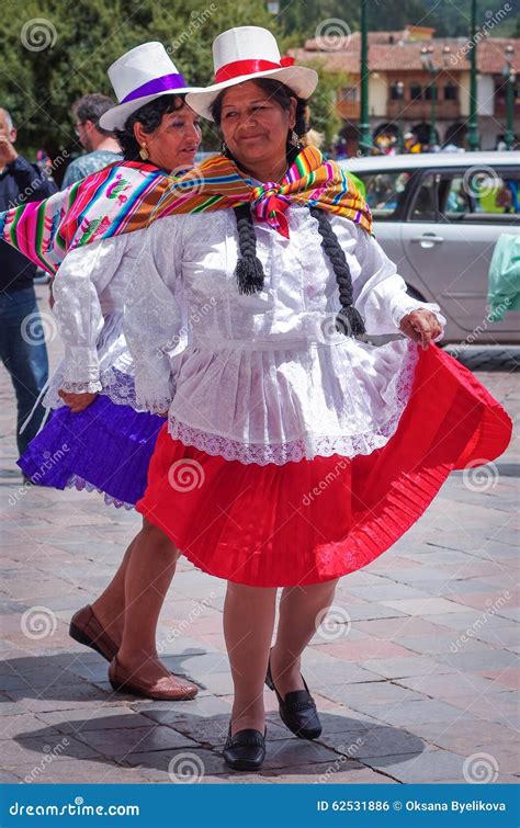 Peruvian Woman In Traditional Dresses Dancing On The Street In Cuzco