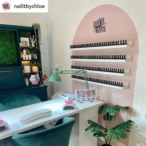 A Room With A Desk Chair And Shelf Filled With Nail Polish Bottles On It