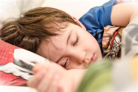 Premium Photo Close Up Of Boy Sleeping On Bed