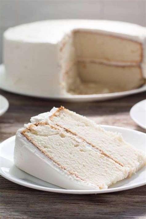 A Slice Of Cake Sitting On Top Of A White Plate Next To Another Piece