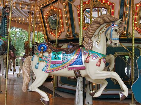 Royalty-Free photo: White, blue, and brown horse carousel | PickPik