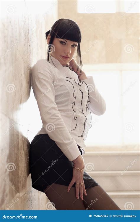 Girl Stands Against The Wall And Stares Into The Camera Stock Image