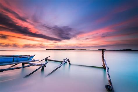 Premium Photo | A boat in the water at sunset