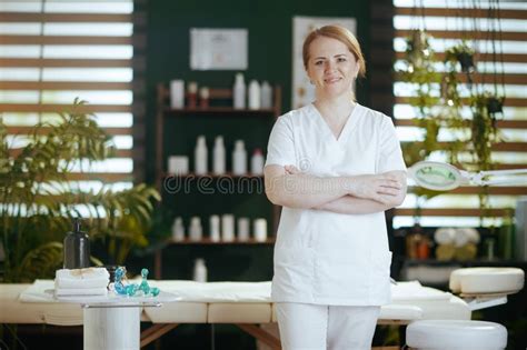 Female Massage Therapist In Massage Cabinet Looking At Camera Stock