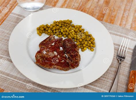 Grilled Beef Steak Garnished With Peas Stock Photo Image Of German