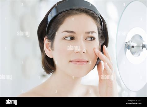 Woman Looking In Mirror Stock Photo Alamy