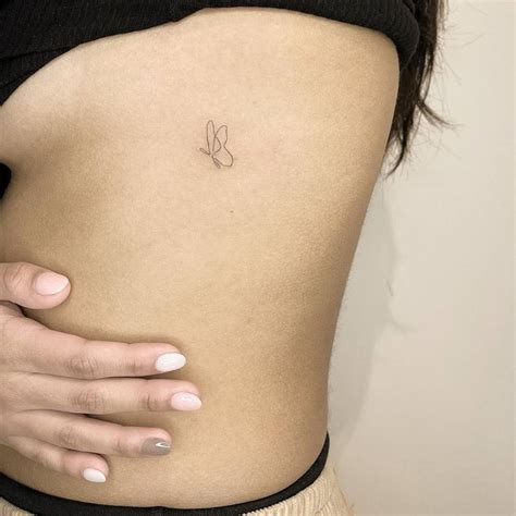 Minimalist Butterfly Tattoo On The Rib