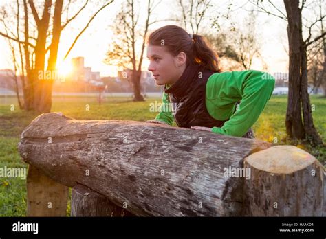 Attractive Brunette Working Out In A Park Stock Photo Alamy
