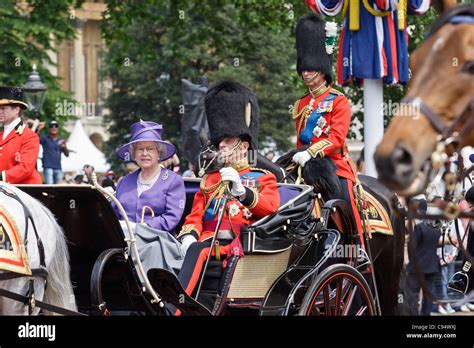 Queen Elizabeth Ii And Prince Philip Traveling By Horse Carriage To