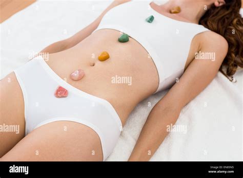 Relaxed Brunette Lying On Mat With Stones Stock Photo Alamy