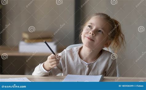 Dreamy Small Girl Lost In Thoughts Distracted From Studying Stock Image