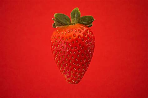 Premium Photo Close Up Of Strawberry Against Red Background