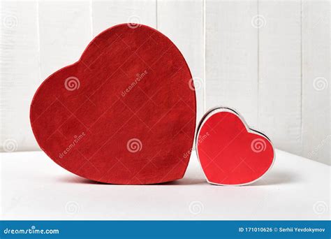 Big And Small Red Heart Shaped Boxes On Table Side View Stock Photo