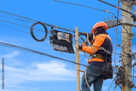 Technician On Wooden Ladder Using Smartphone To Check Data Numbers Of