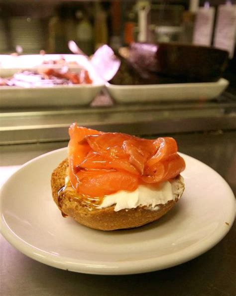 There Is A Bagel With Salmon On It Sitting On A Plate In The Kitchen